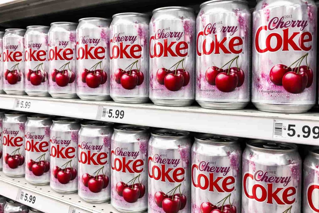 Diet Cherry Coke cans displayed on a grocery store shelf in 2026