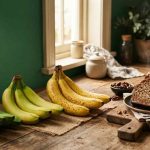 Green bananas turning ripe beside fresh banana bread