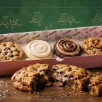 Giant CrumblCookies displayed in a pink box showing the science behind their soft and gooey texture